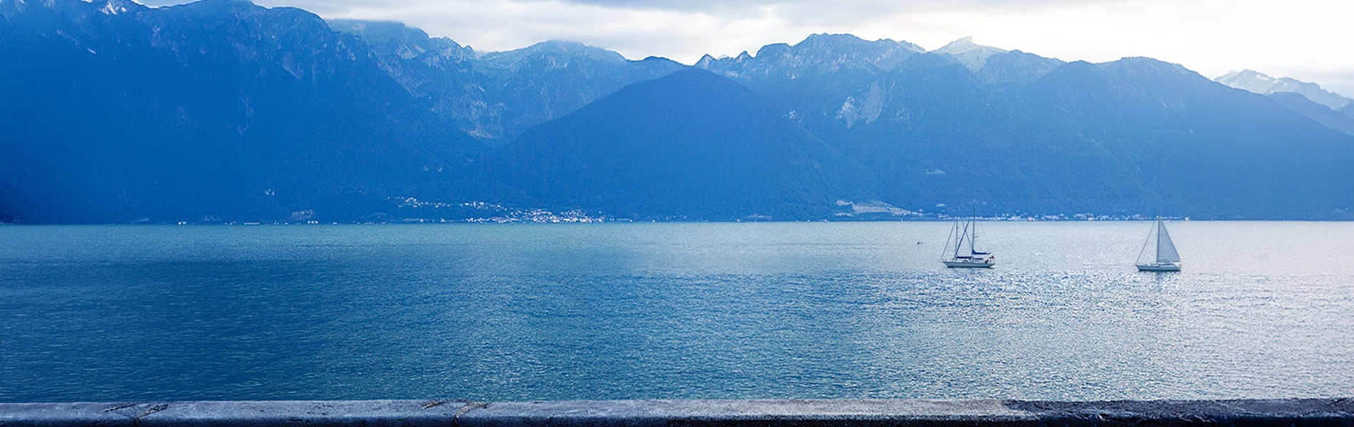 mountain lake with sailboats